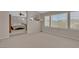 Bright living room featuring large windows with blinds and view to bedroom with queen sized bed at 9017 Cotton Rose Way, Las Vegas, NV 89134