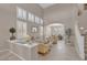 Open-concept living room featuring high ceilings and large windows with plantation shutters at 9017 Cotton Rose Way, Las Vegas, NV 89134
