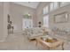 Inviting living room with high ceilings, neutral tones, and a view of the entryway at 9017 Cotton Rose Way, Las Vegas, NV 89134