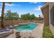 Backyard pool with integrated jacuzzi, brick surround and desert landscaping at 9017 Cotton Rose Way, Las Vegas, NV 89134