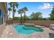 Backyard swimming pool and spa framed by mature palm trees and a desert landscape at 9017 Cotton Rose Way, Las Vegas, NV 89134