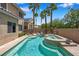 Sparkling backyard pool and spa with mature palm trees, perfect for outdoor relaxation and enjoyment at 9017 Cotton Rose Way, Las Vegas, NV 89134