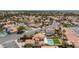 Scenic aerial view of a residential area with homes, pools, and lush green trees, offering a tranquil atmosphere at 9817 Dardanelle Ct, Las Vegas, NV 89117