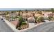 Picturesque aerial view of a suburban home with a private pool, lush landscaping and charming curb appeal at 9817 Dardanelle Ct, Las Vegas, NV 89117