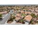 Expansive aerial view showcasing a home with a pool, green lawn, and well-manicured landscaping in a neighborhood at 9817 Dardanelle Ct, Las Vegas, NV 89117