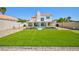 Lush backyard featuring a pool, putting green and manicured lawn for outdoor activities at 9817 Dardanelle Ct, Las Vegas, NV 89117