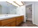 Bathroom featuring double sinks, wood-look flooring, and tiled shower at 9817 Dardanelle Ct, Las Vegas, NV 89117