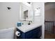 Well-lit bathroom with a modern mirror and blue vanity for ample storage at 9817 Dardanelle Ct, Las Vegas, NV 89117