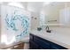 Bathroom features a spacious vanity and a shower with stylish blue patterned curtain at 9817 Dardanelle Ct, Las Vegas, NV 89117