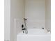 Modern bathtub with a black shower head and white tile surround at 9817 Dardanelle Ct, Las Vegas, NV 89117