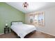 Comfortable bedroom featuring a large window and a ceiling fan with light at 9817 Dardanelle Ct, Las Vegas, NV 89117