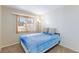 This cozy bedroom is brightened by a window with outside view at 9817 Dardanelle Ct, Las Vegas, NV 89117