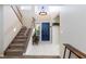 Grand two-story foyer with staircase, tiled flooring, and modern chandelier at 9817 Dardanelle Ct, Las Vegas, NV 89117