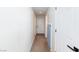 Hallway with white walls and carpet flooring leads to a white door at 9817 Dardanelle Ct, Las Vegas, NV 89117