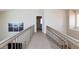 Upstairs hallway landing with view to another bedroom and downstairs at 9817 Dardanelle Ct, Las Vegas, NV 89117