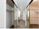 Hallway with mirrored closet doors leads to bathroom featuring tile flooring at 9817 Dardanelle Ct, Las Vegas, NV 89117