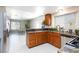 Bright kitchen features wooden cabinets, granite countertops, stainless steel appliances, and tiled floor at 9817 Dardanelle Ct, Las Vegas, NV 89117