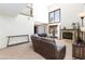 Spacious living room with fireplace, large windows, and comfortable leather sofa at 9817 Dardanelle Ct, Las Vegas, NV 89117