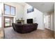 Open living room with fireplace, large windows, and a comfortable sectional sofa at 9817 Dardanelle Ct, Las Vegas, NV 89117