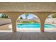 Covered patio view of backyard pool and manicured landscaping at 9817 Dardanelle Ct, Las Vegas, NV 89117