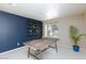 Bright room with a blue accent wall, large windows and a wooden table at 9817 Dardanelle Ct, Las Vegas, NV 89117