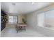 Bright room with large windows, tiled floors, and a wooden table at 9817 Dardanelle Ct, Las Vegas, NV 89117