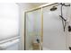 Walk in shower with gold trim and tiled walls at 9817 Dardanelle Ct, Las Vegas, NV 89117