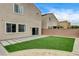 Landscaped backyard with artificial grass, and gravel, surrounded by a block fence at 9870 Fisher Bay Ct, Las Vegas, NV 89178