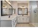 Bathroom with dual sinks, white cabinets, quartz countertop and glass enclosed shower at 9870 Fisher Bay Ct, Las Vegas, NV 89178