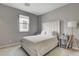 Bright bedroom featuring a neutral color scheme, plush carpet, and a cozy window at 9870 Fisher Bay Ct, Las Vegas, NV 89178