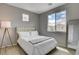 Bedroom with light walls, plush carpet, and a large window providing ample natural light at 9870 Fisher Bay Ct, Las Vegas, NV 89178