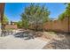 Large backyard with mature landscaping, a patio area, and drought-tolerant desert rock ground cover at 10121 Iron Wood Peak Ave, Las Vegas, NV 89166