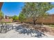 Spacious backyard featuring a concrete patio, desert landscaping, and ample room for outdoor seating at 10121 Iron Wood Peak Ave, Las Vegas, NV 89166