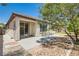 Private backyard with concrete patio, desert landscaping, and mature trees for shade and privacy at 10121 Iron Wood Peak Ave, Las Vegas, NV 89166