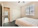 Bedroom featuring wood flooring and a large window at 10121 Iron Wood Peak Ave, Las Vegas, NV 89166