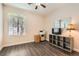 Bedroom area featuring wood flooring, large window, and ceiling fan at 10121 Iron Wood Peak Ave, Las Vegas, NV 89166