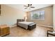 Neutral bedroom with ceiling fan and window with blinds at 10121 Iron Wood Peak Ave, Las Vegas, NV 89166