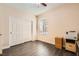 Bedroom featuring wood flooring, closet, and a large window at 10121 Iron Wood Peak Ave, Las Vegas, NV 89166