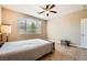 Bedroom features a ceiling fan, large window, and tile flooring at 10121 Iron Wood Peak Ave, Las Vegas, NV 89166