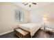 Bedroom featuring a ceiling fan, large window, and wood flooring at 10121 Iron Wood Peak Ave, Las Vegas, NV 89166
