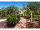 Picturesque community park path with lush greenery, a graceful archway, and a charming pergola at 10121 Iron Wood Peak Ave, Las Vegas, NV 89166