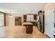 Modern kitchen with stainless appliances, granite countertops and breakfast bar open to the dining area at 10121 Iron Wood Peak Ave, Las Vegas, NV 89166