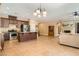 Modern kitchen with stainless appliances, granite countertops and breakfast bar open to the living area at 10121 Iron Wood Peak Ave, Las Vegas, NV 89166