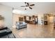 Open concept living room with tile flooring connecting to kitchen and dining areas at 10121 Iron Wood Peak Ave, Las Vegas, NV 89166