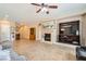 Spacious living room featuring a fireplace, built-in shelving and tile flooring at 10121 Iron Wood Peak Ave, Las Vegas, NV 89166