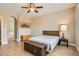 Neutral primary bedroom with ceiling fan and en suite bathroom at 10121 Iron Wood Peak Ave, Las Vegas, NV 89166