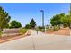 Inviting park entrance with manicured landscaping, walking path, and community signage at 10121 Iron Wood Peak Ave, Las Vegas, NV 89166
