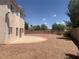 Large backyard features neutral landscaping and a concrete patio at 10357 Bent Willow Ave, Las Vegas, NV 89129