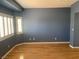 Bedroom with hardwood floors, neutral paint, and windows with views at 10357 Bent Willow Ave, Las Vegas, NV 89129
