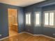 Bedroom with hardwood floors, shuttered windows, and ensuite bathroom with glass shower at 10357 Bent Willow Ave, Las Vegas, NV 89129